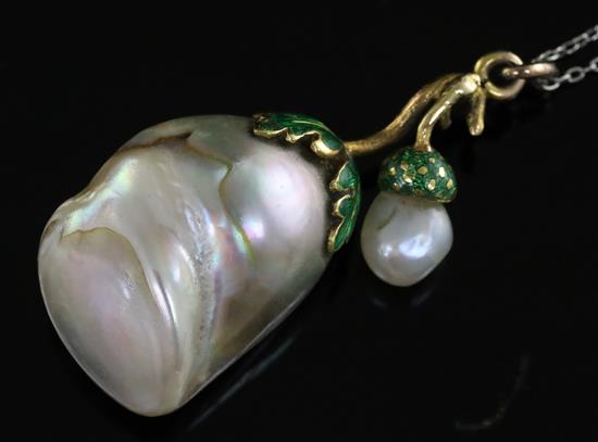 A gold and green enamel mounted natural saltwater oval and large baroque pearl pendant, on a platinum fine link chain.